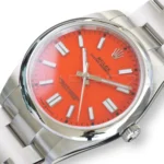 Rolex 124300-0007 coral red lacquer dial white gold baton markers Chromalight hands pristine close-up